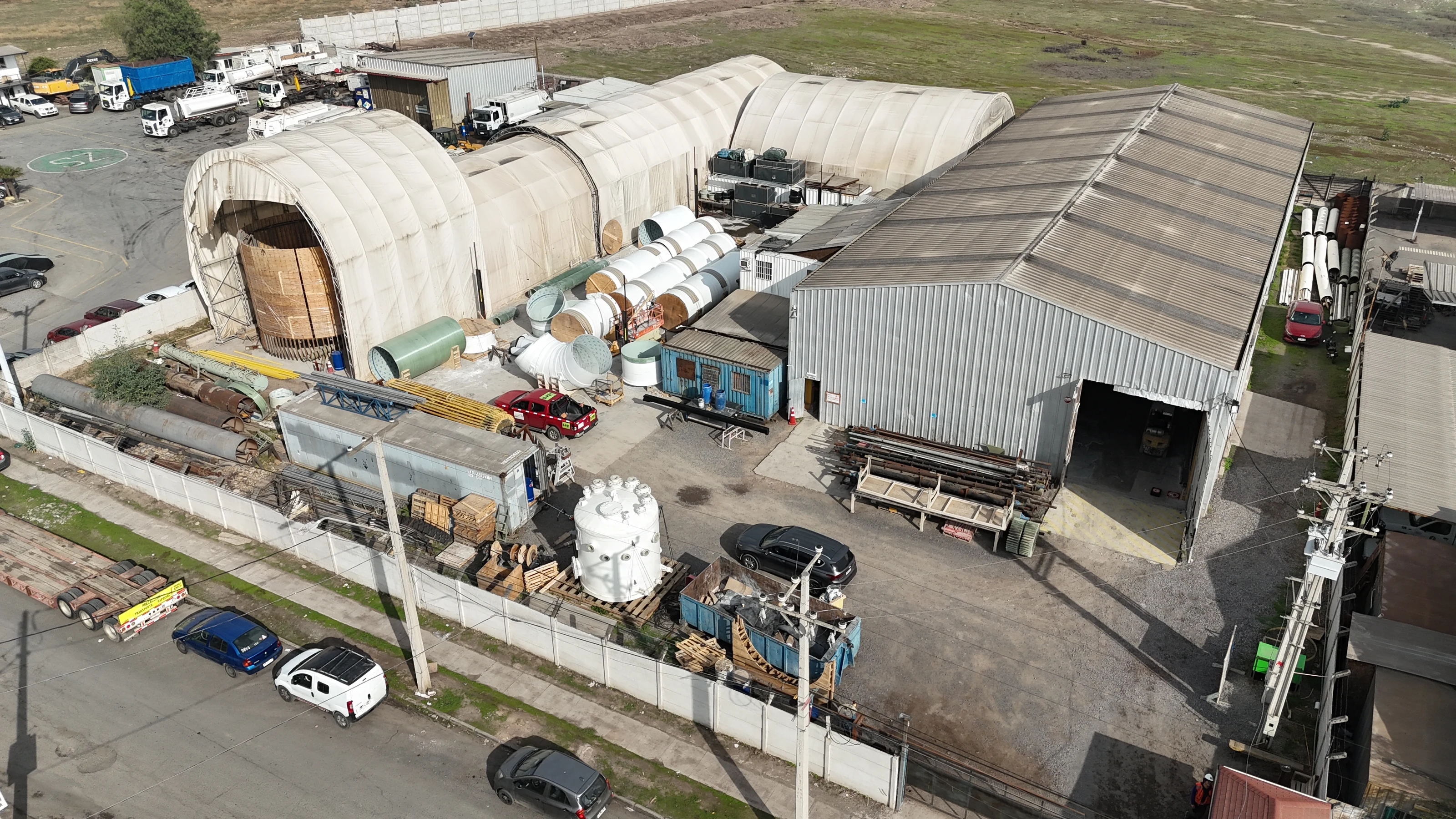 Aerial view of the plant, with the fabrication tents, the metal warehouse and equipment and ducts laid out in the yard.