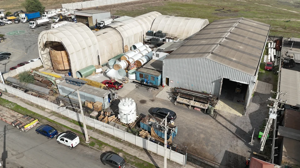 Aerial view of the plant, with the fabrication tents, the metal warehouse and equipment and ducts laid out in the yard.