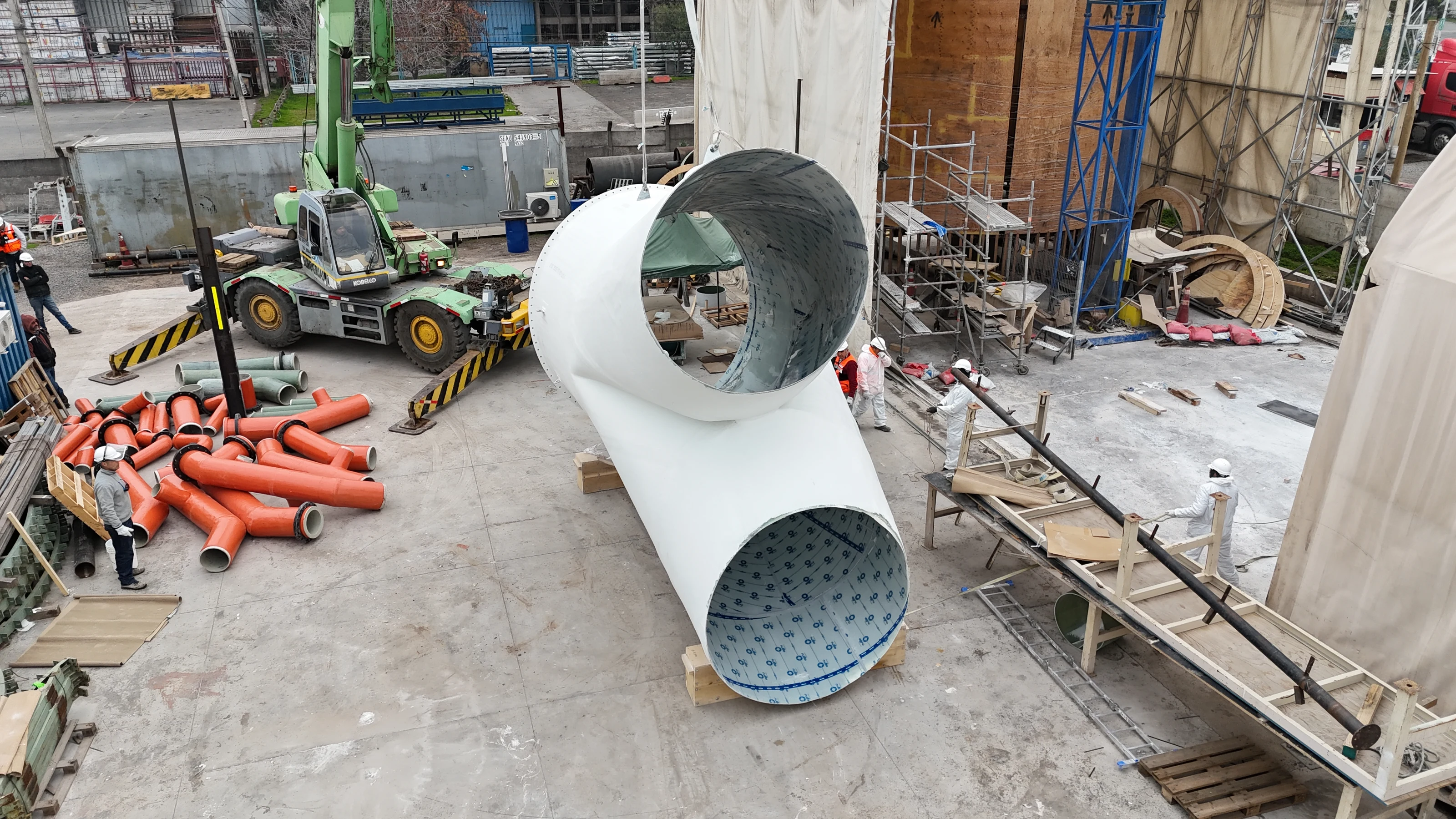 Pants duct parts in the fabrication yard, next to a crane and other components in progress.