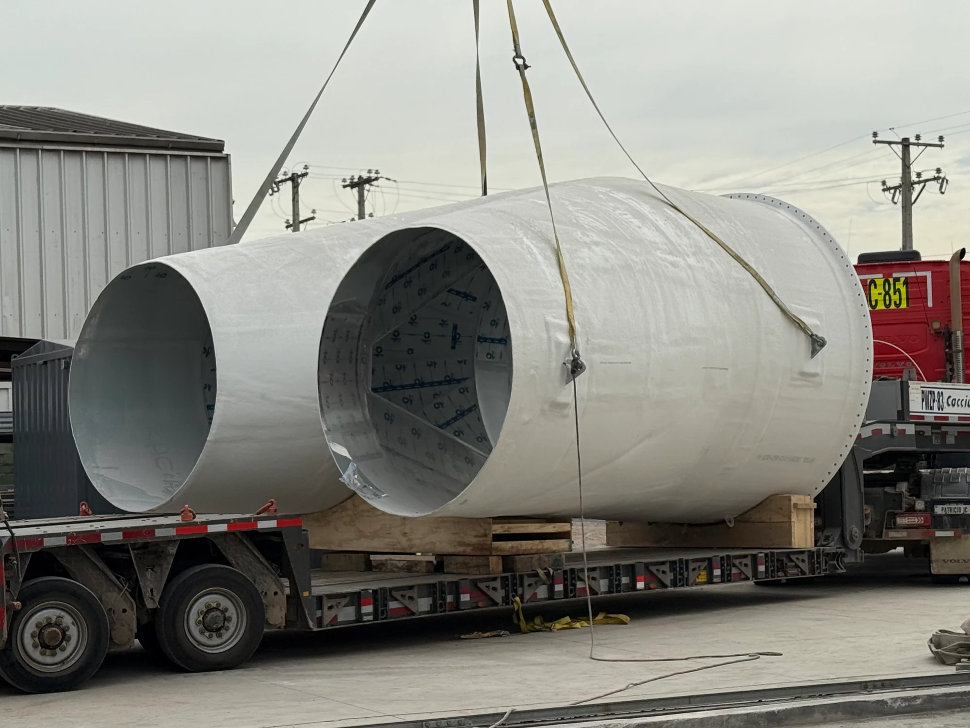 Pants duct section being loaded onto a truck by crane.