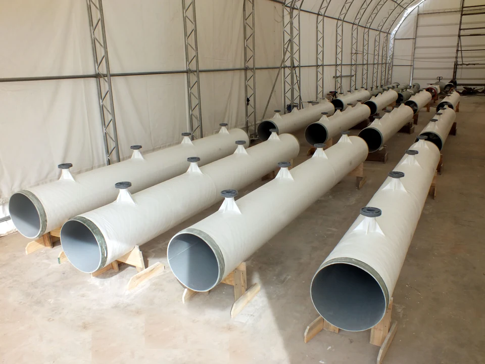 Industrial FRP duct sections arranged on supports, ready for dispatch.