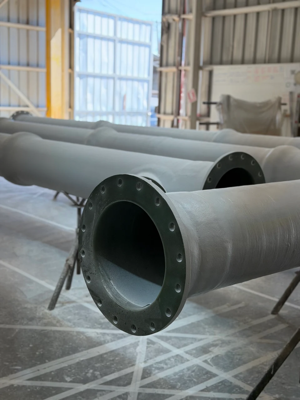 FRP pipes stored in the workshop, ready for dispatch.
