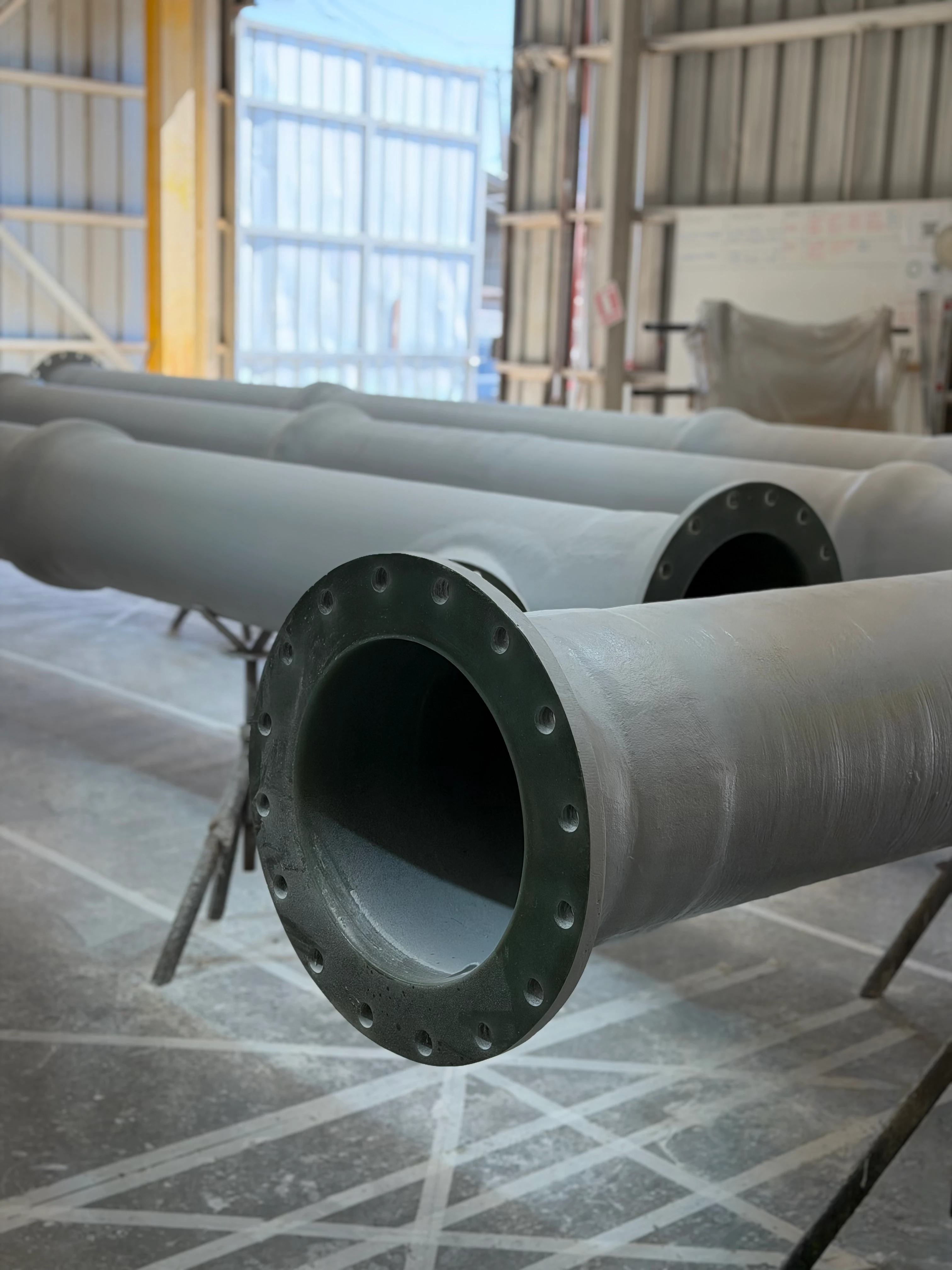 FRP pipes stored in the workshop, ready for dispatch.